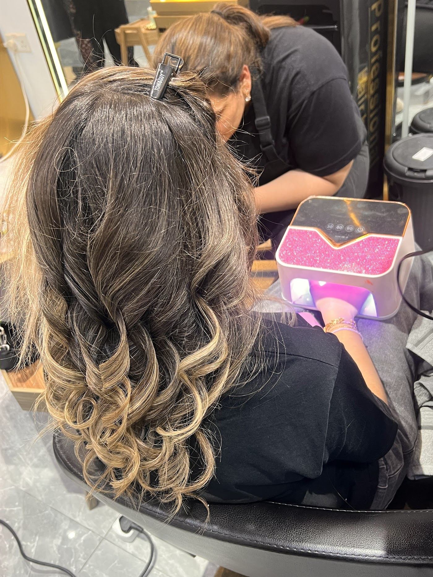 Client with soft waves while getting her nails done