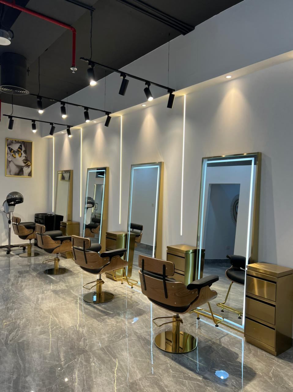 Inside KRG Ladies Salon: gold-framed lit mirrors and styling chairs