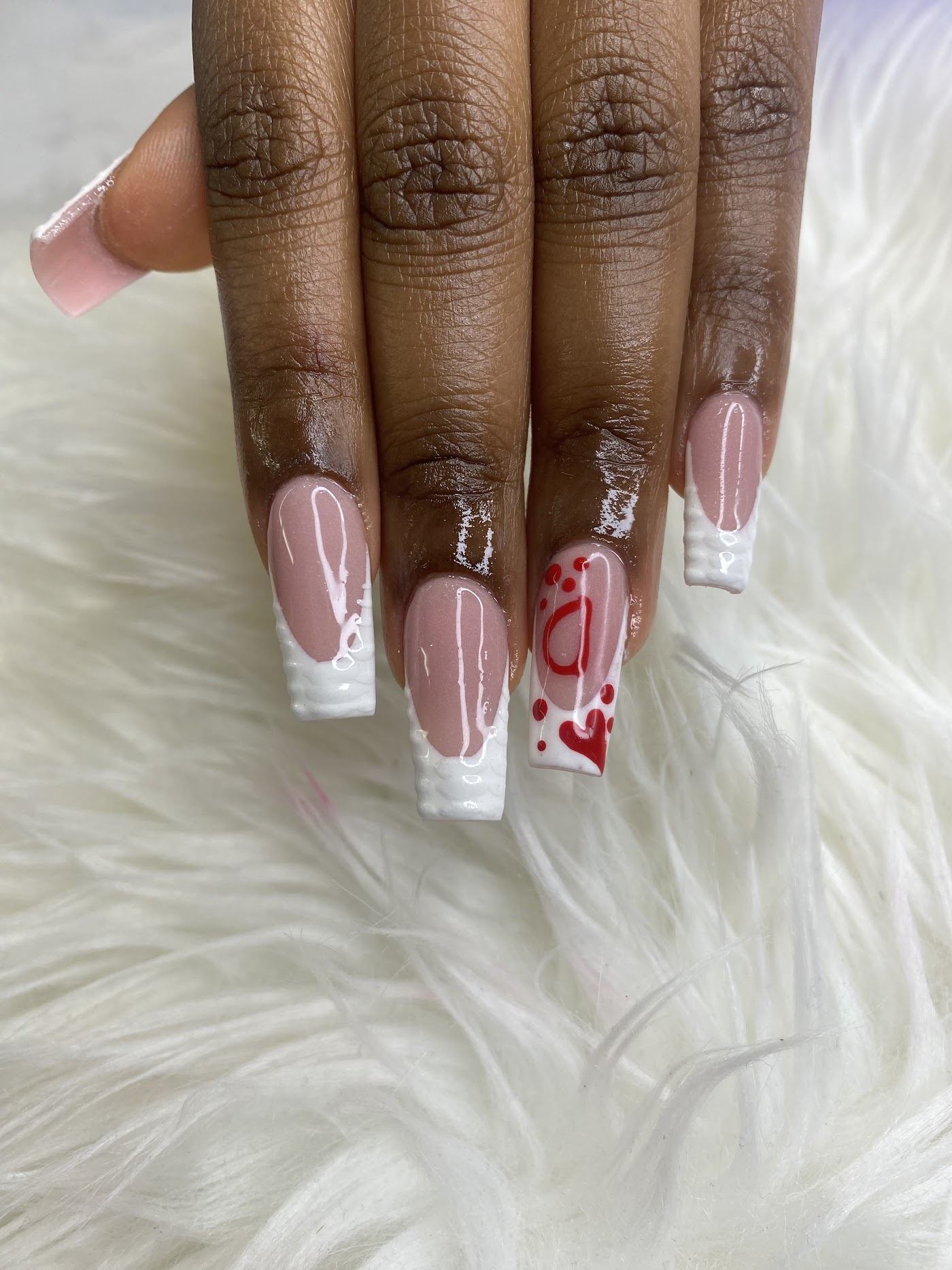 Long French-tip nail extensions with heart art